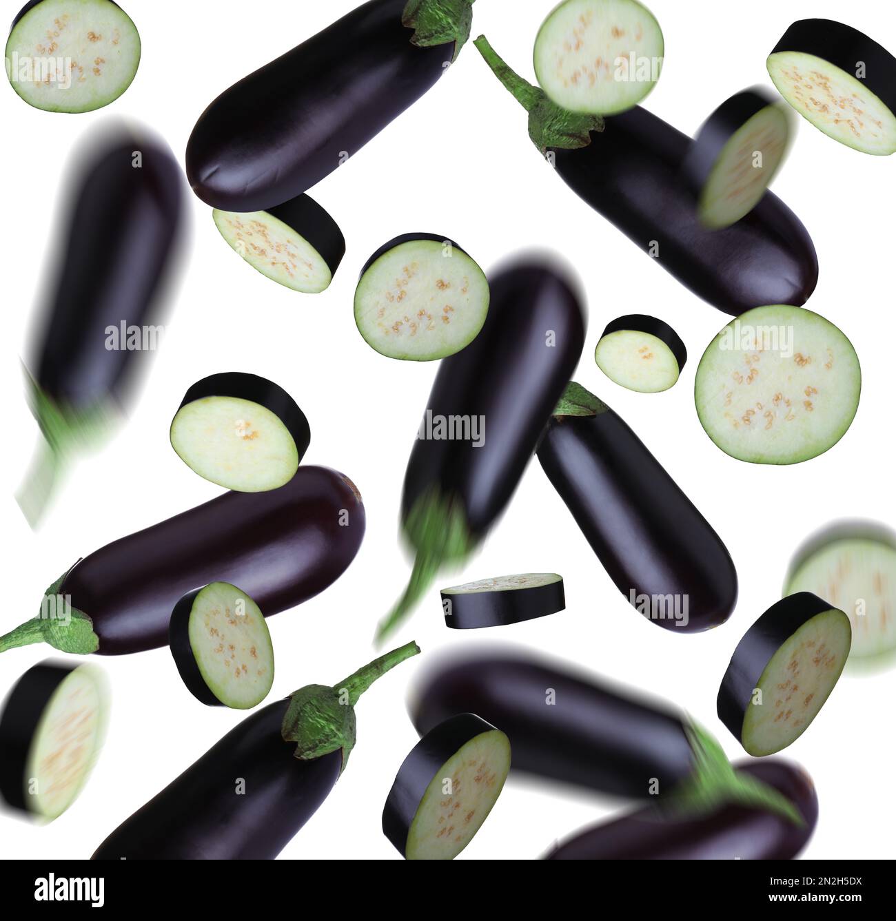 Cut and whole eggplants falling on white background Stock Photo Alamy