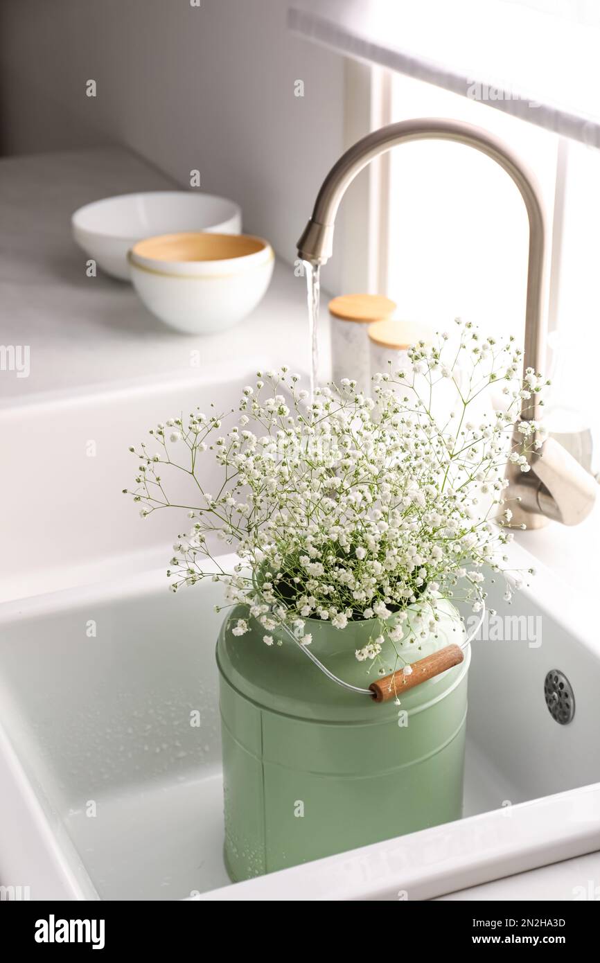 Bouquet of gypsophila flowers in sink. Kitchen interior design Stock
