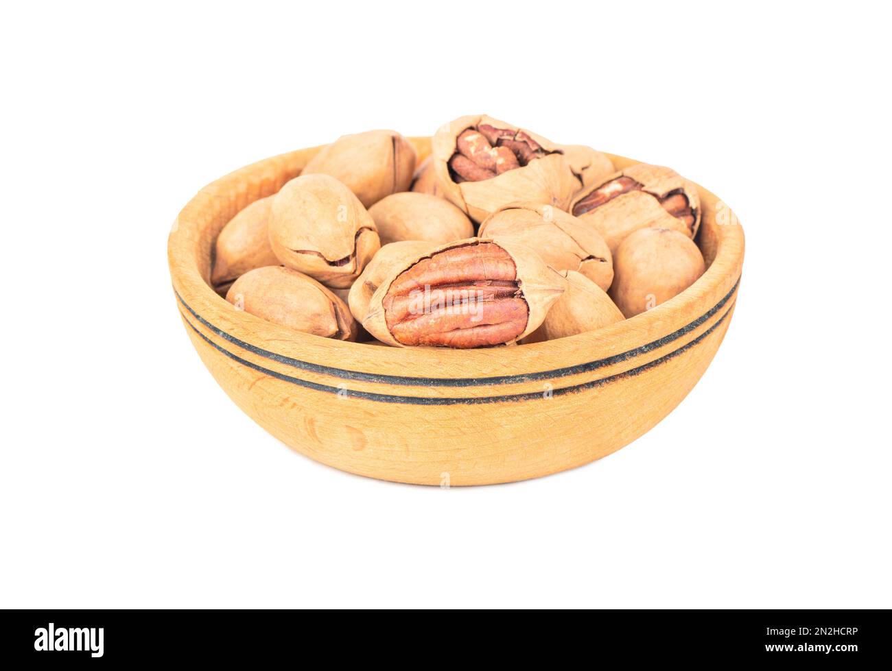 Pecan nuts in a large wooden bowl on a white background Stock Photo