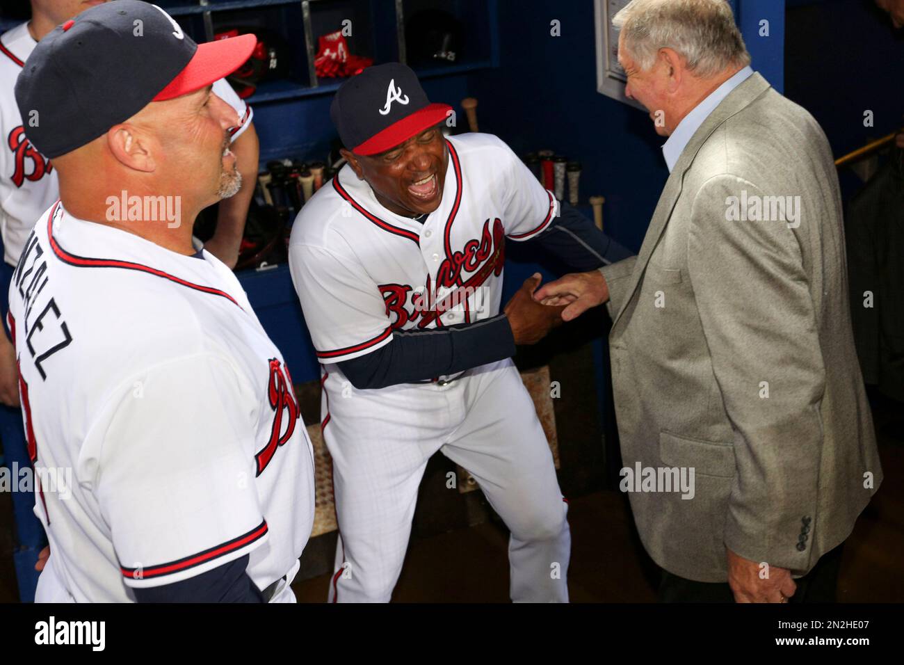 Atlanta Braves' Terry Pendleton, left, has a laugh with former Braves  Manager Bobby Cox, right, in the dugout as Braves Manager Fredi Gonzalez  looks on in the dugout prior to the baseball