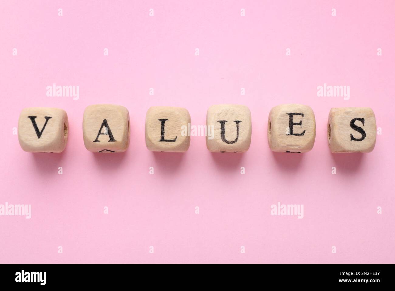 Beads with word VALUES on pink background, flat lay Stock Photo