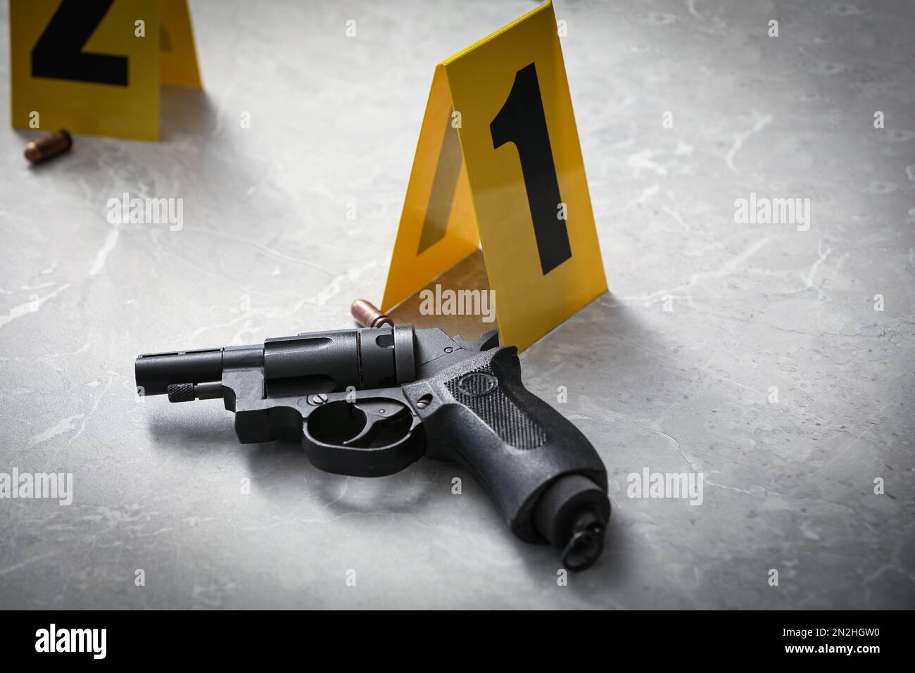 Handgun and crime scene marker on light grey marble table Stock Photo ...