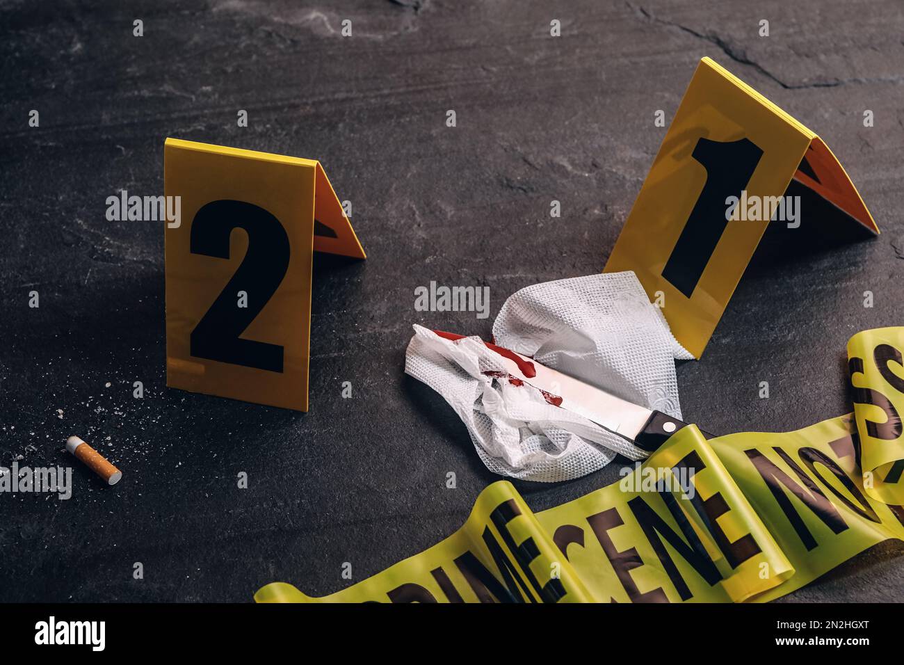 Crime scene markers and evidences on black background Stock Photo - Alamy