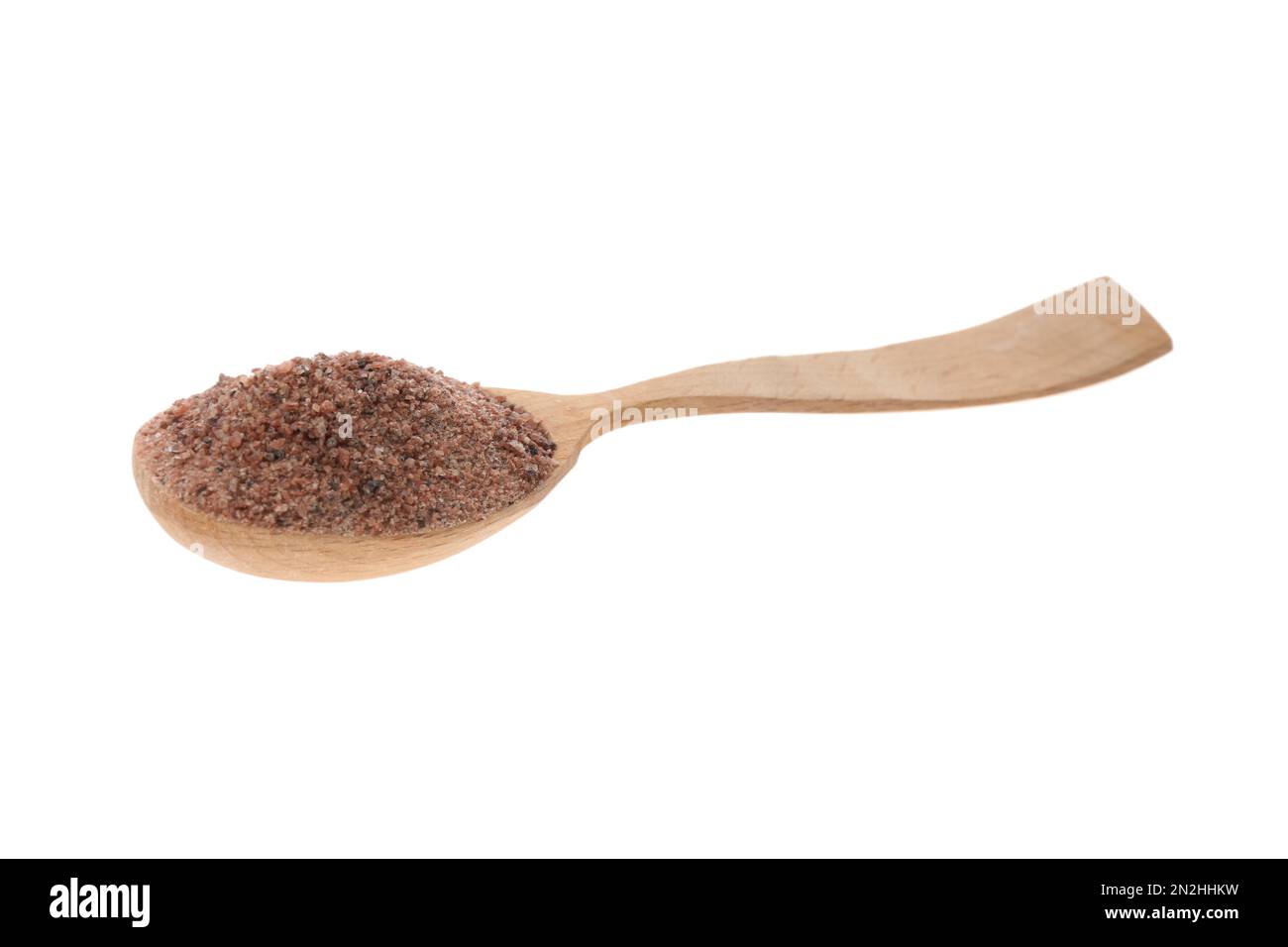 Ground black salt in spoon isolated on white Stock Photo