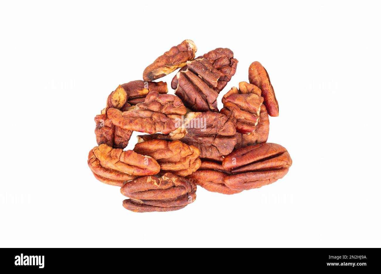Small pile of dry pecan halves without shell isolated on white background. Stock Photo