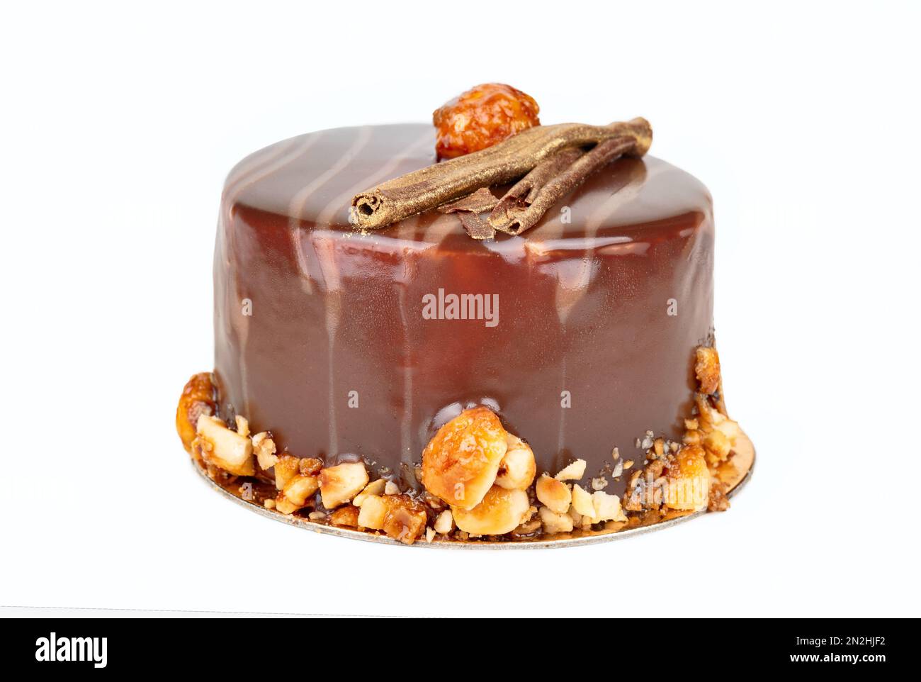 Chocolate cake with salty and sweet caramel inside, doused with icing with nuts. Very tender and tasty dessert. Stock Photo
