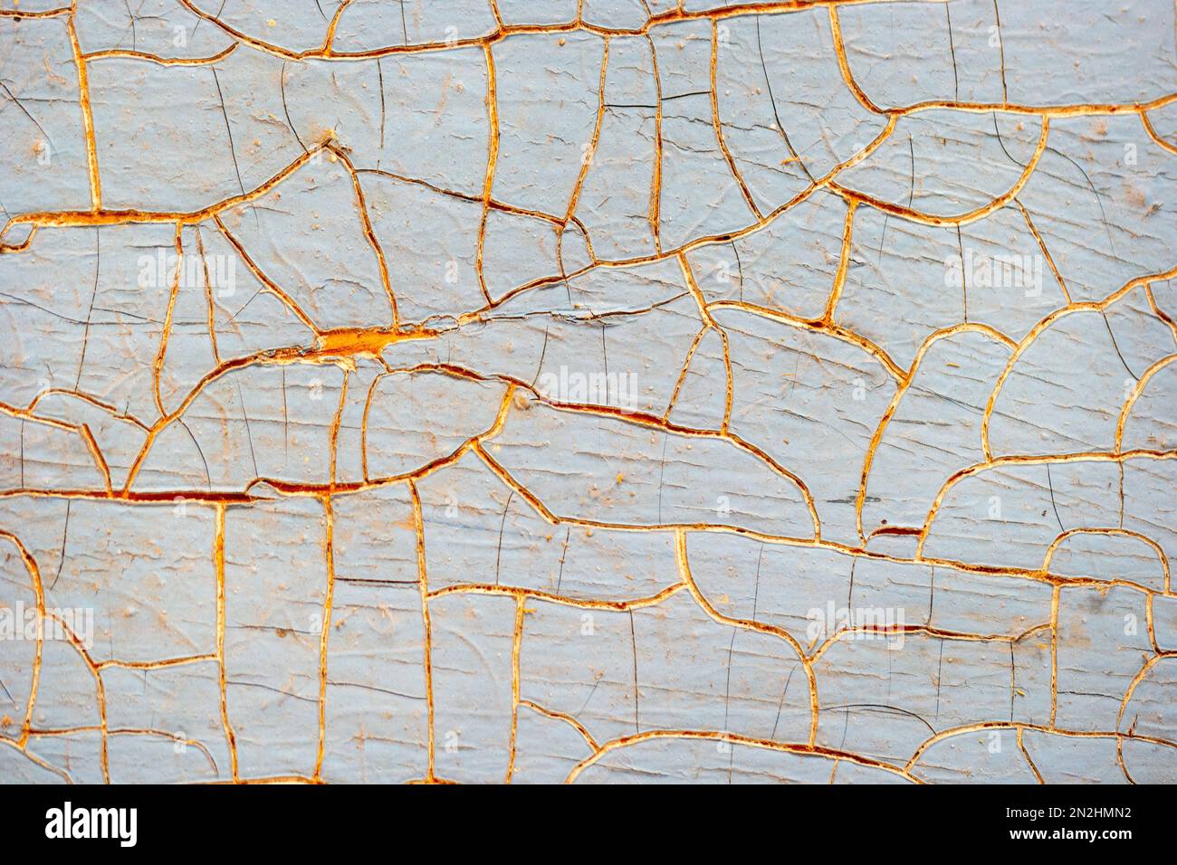 Background of old cracked blue sun-bleached paint on wood. Stock Photo
