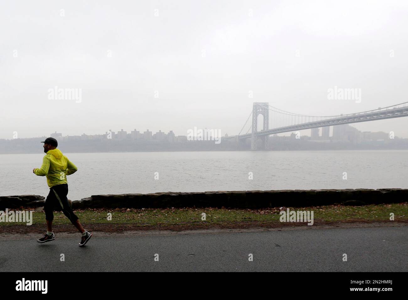 A runner trots at Palisades Interstate Park as fog blankets over the