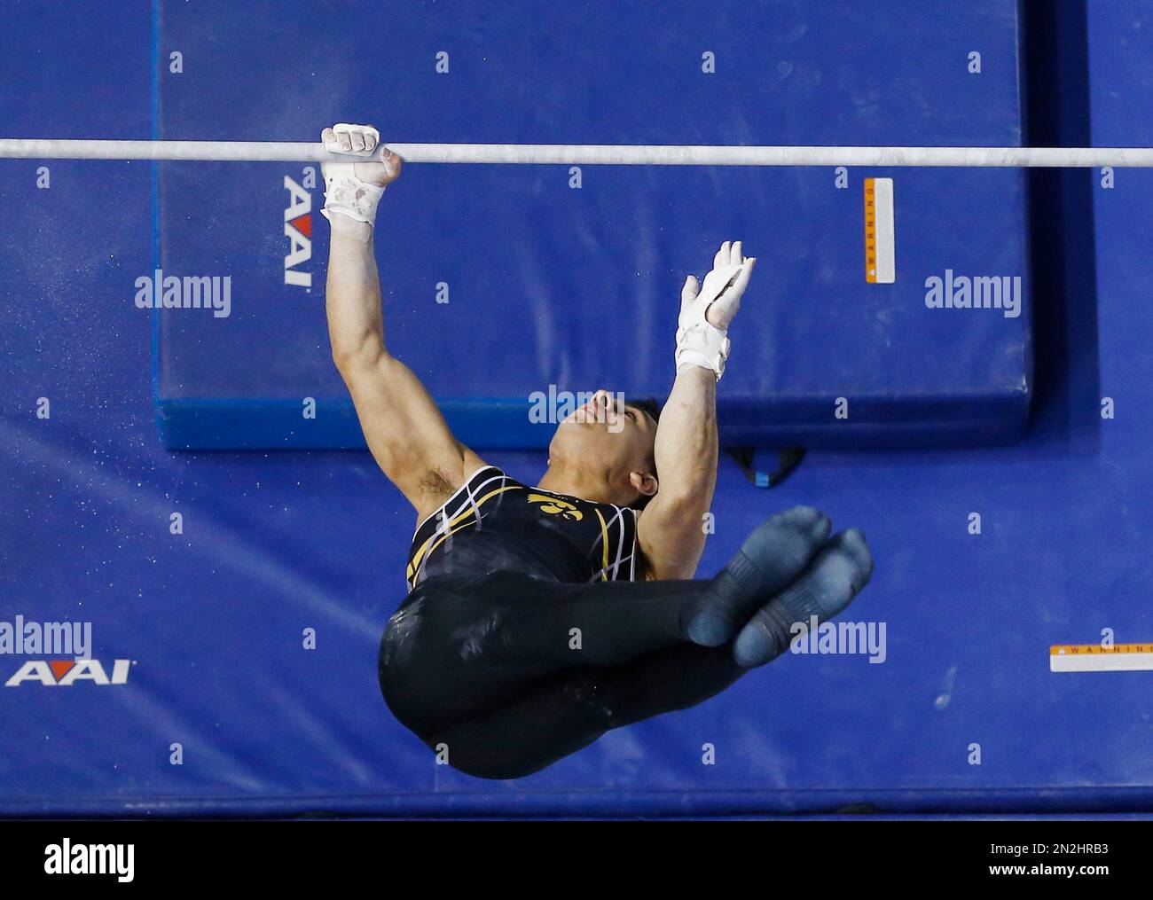 Iowa's Cyrus Dobre-Mofid competes on the high bar during a preliminary roiund of the NCAA men's
