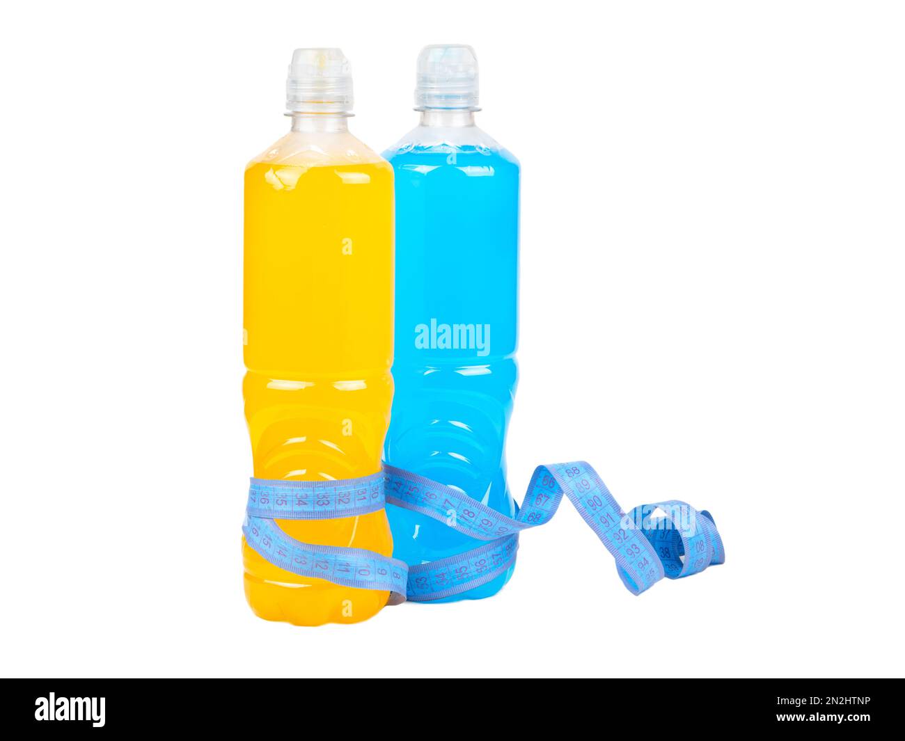 Two plastic bottles with orange and blue isotonic drinks wrapped in a measuring centimeter isolated on a white background. Stock Photo