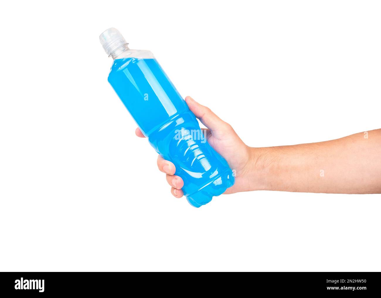 Plastic bottle with blue isotonic drink in male hand isolated on white background. Stock Photo