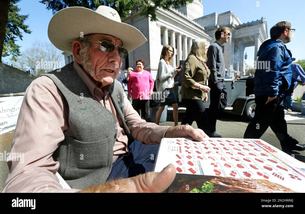Charlie Card, a cattle rancher from Prosser, Wash., hands out recipes ...