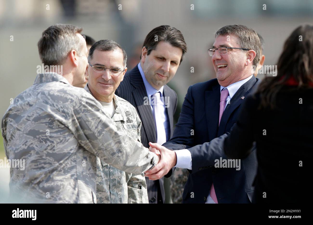 U.S. Defense Secretary Ash Carter, right, shakes hands with 7th Air