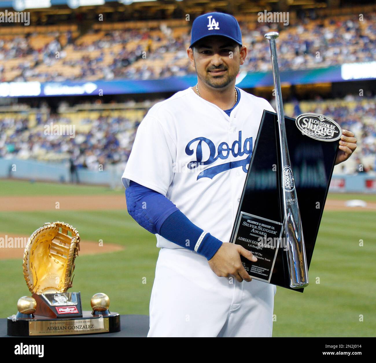 Los Angeles Dodgers' Adrian Gonzalez holds up his Silver Slugger Award