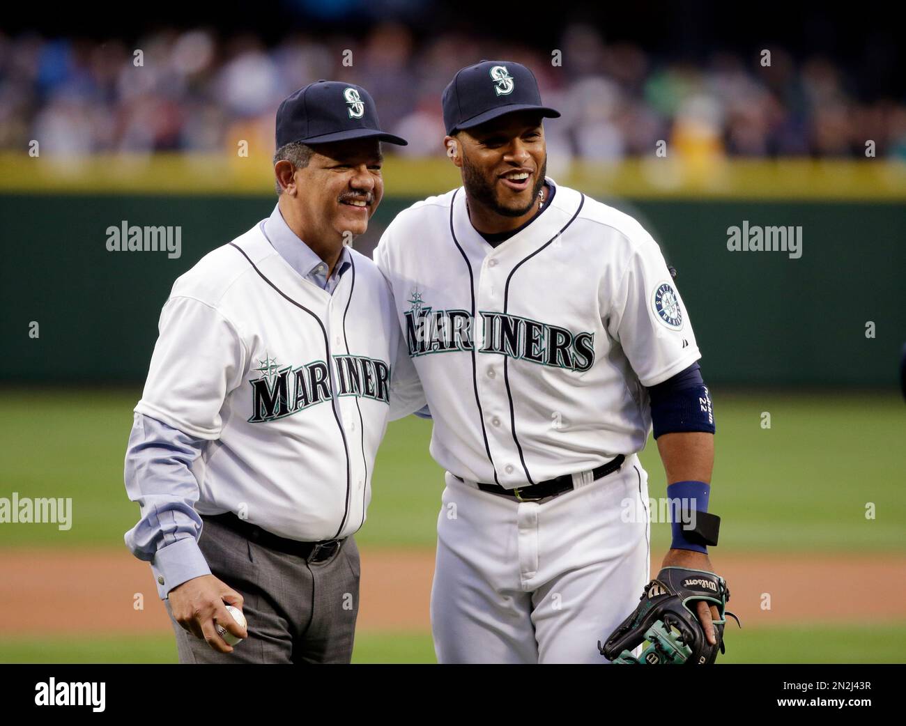 Former Dominican Republic President Leonel Fernandez, left, smiles as he stands with Seattle Mariners' Robinson Cano after Fernandez threw out the ceremonial first pitch before a baseball game between the Mariners and the Los Angeles Angels Tuesday, April 7, 2015, in Seattle. (AP Photo/Elaine Thompson) Stock Photo