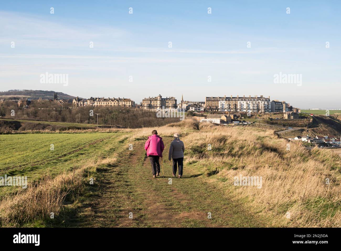 Two female walkers on the Cleveland Way approaching Saltburn in North Yorkshire, England, UK Stock Photo