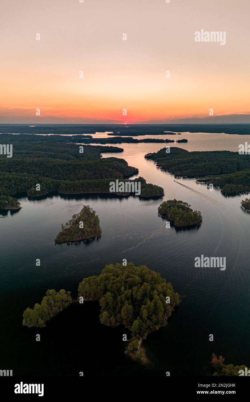 An aerial view of lake surrounded by dense trees Stock Photo - Alamy