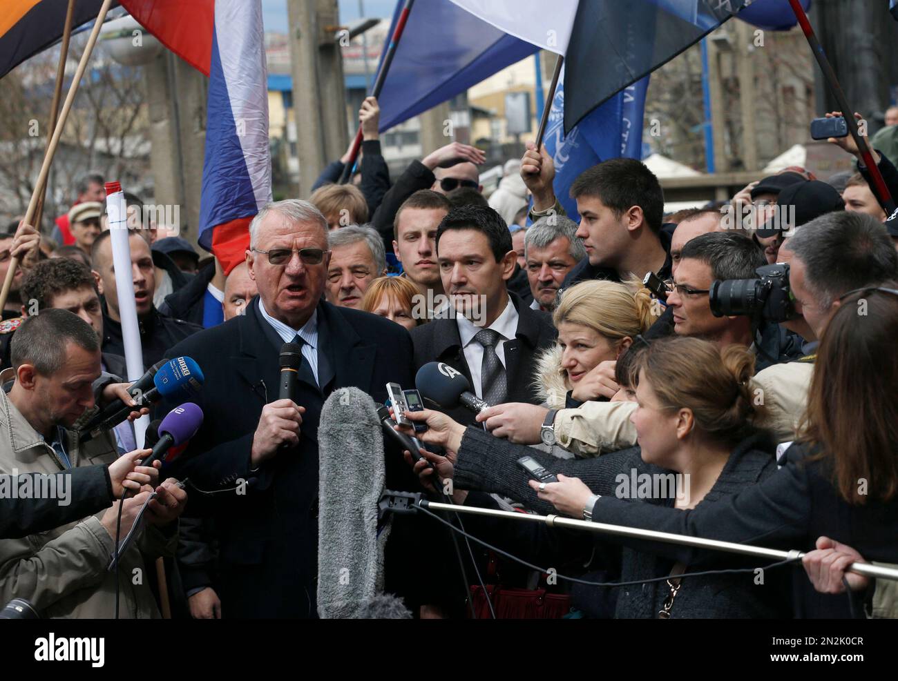 Serbian far right leader Vojislav Seselj, who is accused of war crimes by a U.N. court, addresses the media at a protest in front of the Higher Court in Belgrade, Serbia, Wednesday, April 1, 2015. Serbia's Foreign Minister Ivica Dacic on Tuesday denounced a Hague Tribunal ruling that far-right leader Vojislav Seselj must return to the court's prison. (AP Photo/Darko Vojinovic) Stock Photo
