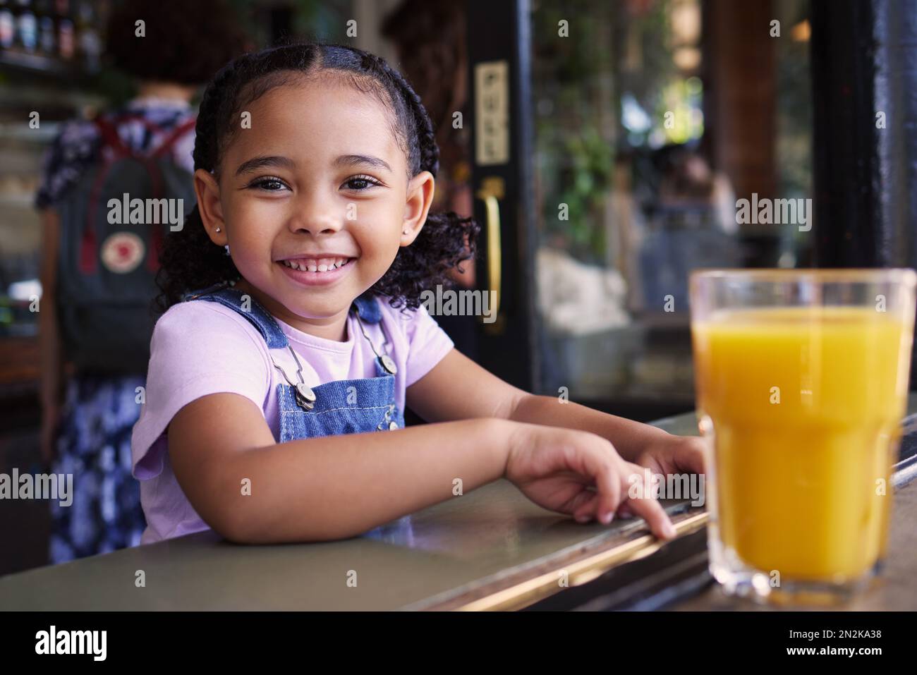 Happy, smile and portrait of a child at a restaurant for food