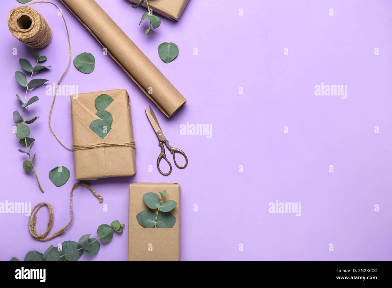 Composition with gift boxes, wrapping paper, rope and eucalyptus