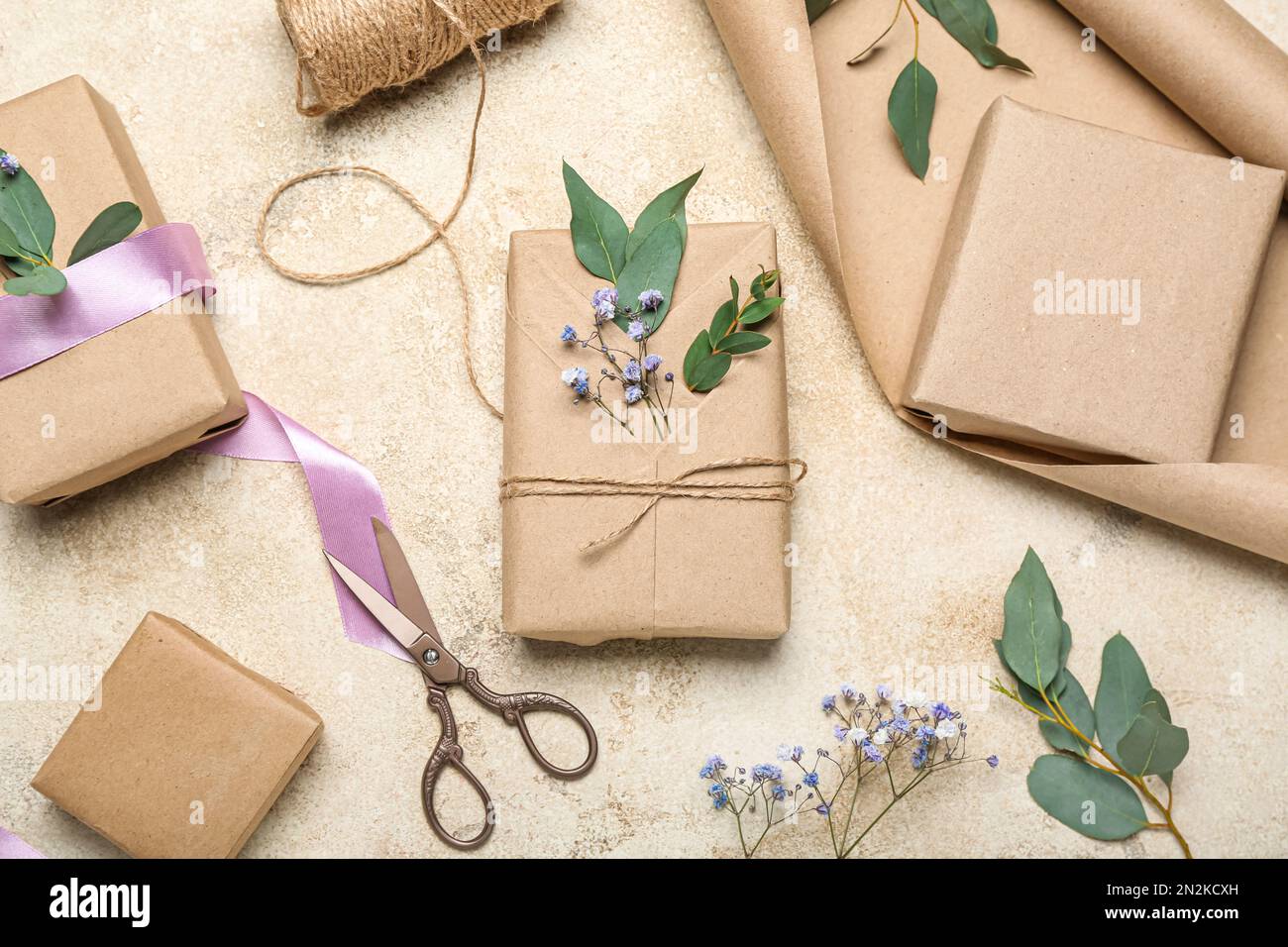 Composition with gift boxes, wrapping paper, rope and gypsophila