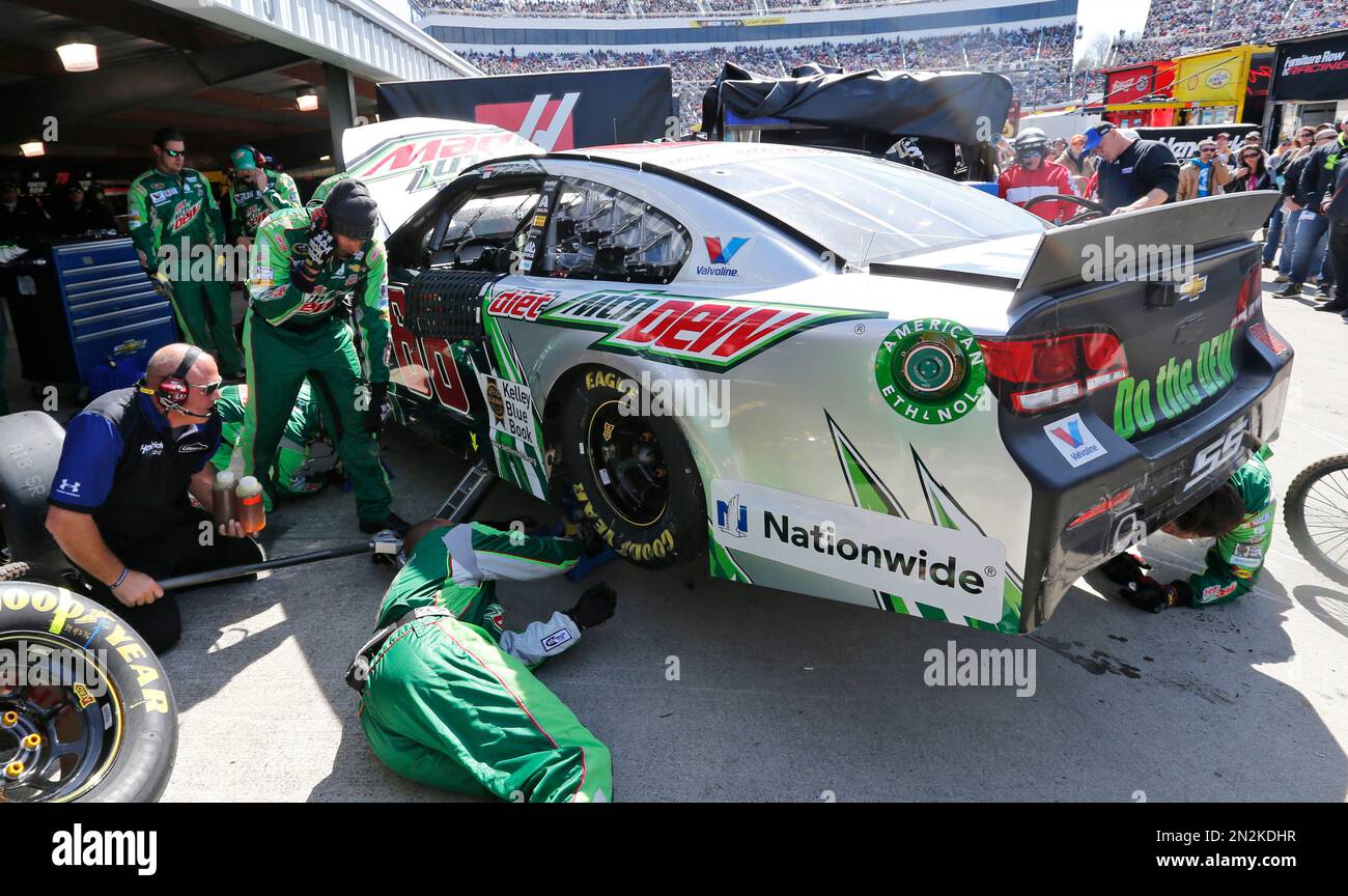 The pit crew for Dale Earnhardt Jr. works on his car after it was