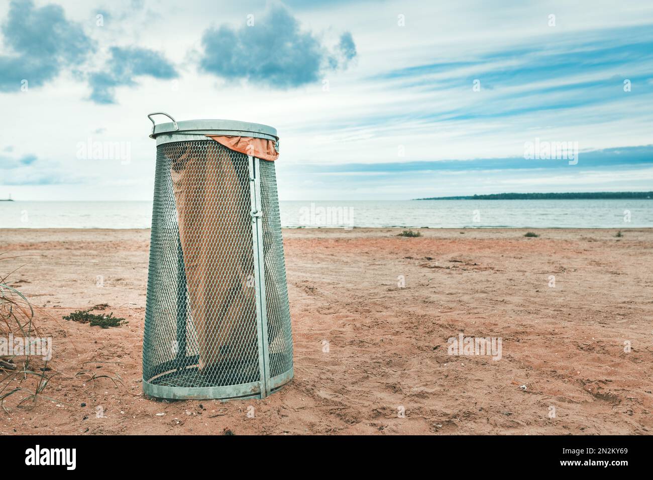 Garbage bin on beach sand in Halmstad, Sweden. Selective focus Stock