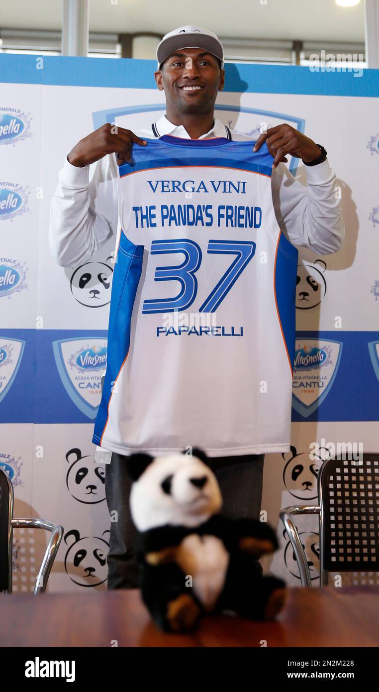 Former NBA All-Star Metta World Peace poses with a Pallacanestro Cantu  jersey in Milan, Italy, Thursday, March 26, 2015. Former NBA All-Star Metta  World Peace has signed for Italian team Pallacanestro Cantu