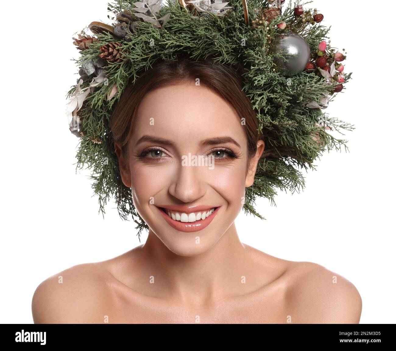 Beautiful young woman wearing Christmas wreath on white background Stock Photo