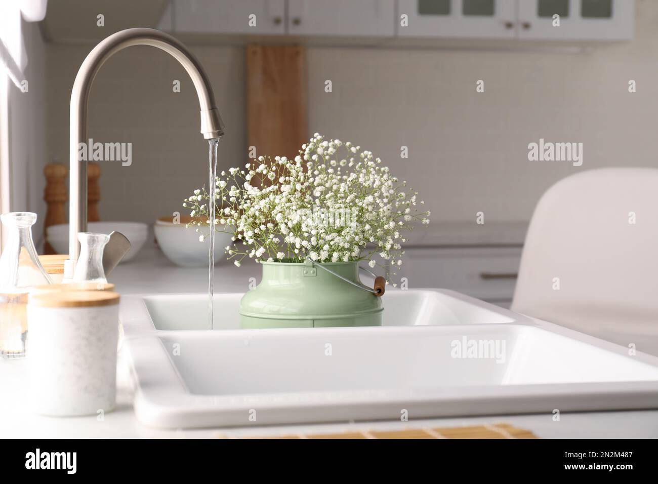 Bouquet of gypsophila flowers in sink. Kitchen interior design Stock