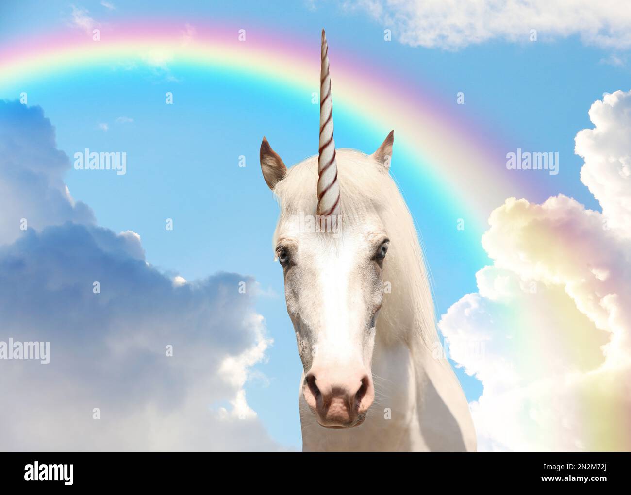 Magic unicorn in beautiful sky with rainbow and fluffy clouds. Fantasy ...