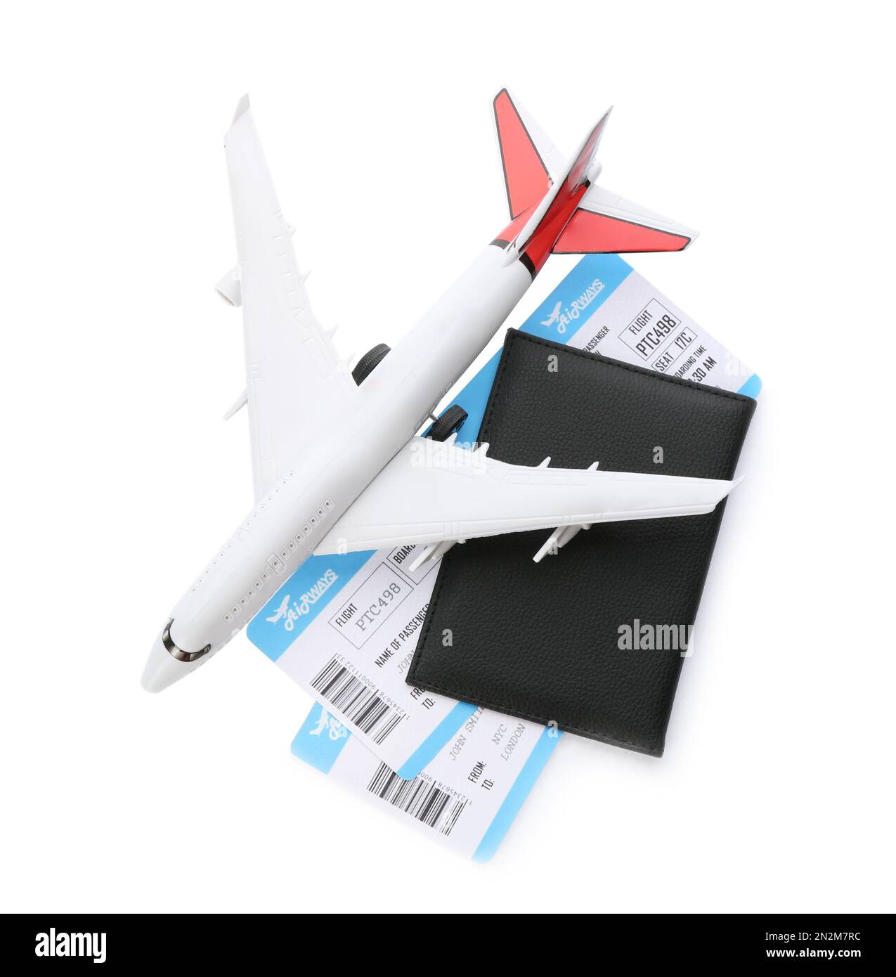 Toy airplane and passport with tickets on white background, top view Stock Photo