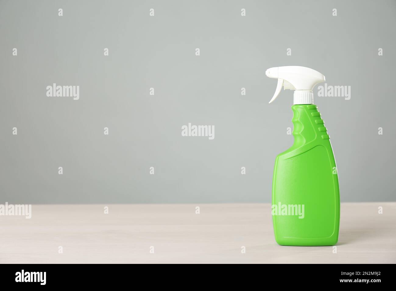 Bottle of cleaning product on light table. Space for text Stock Photo ...