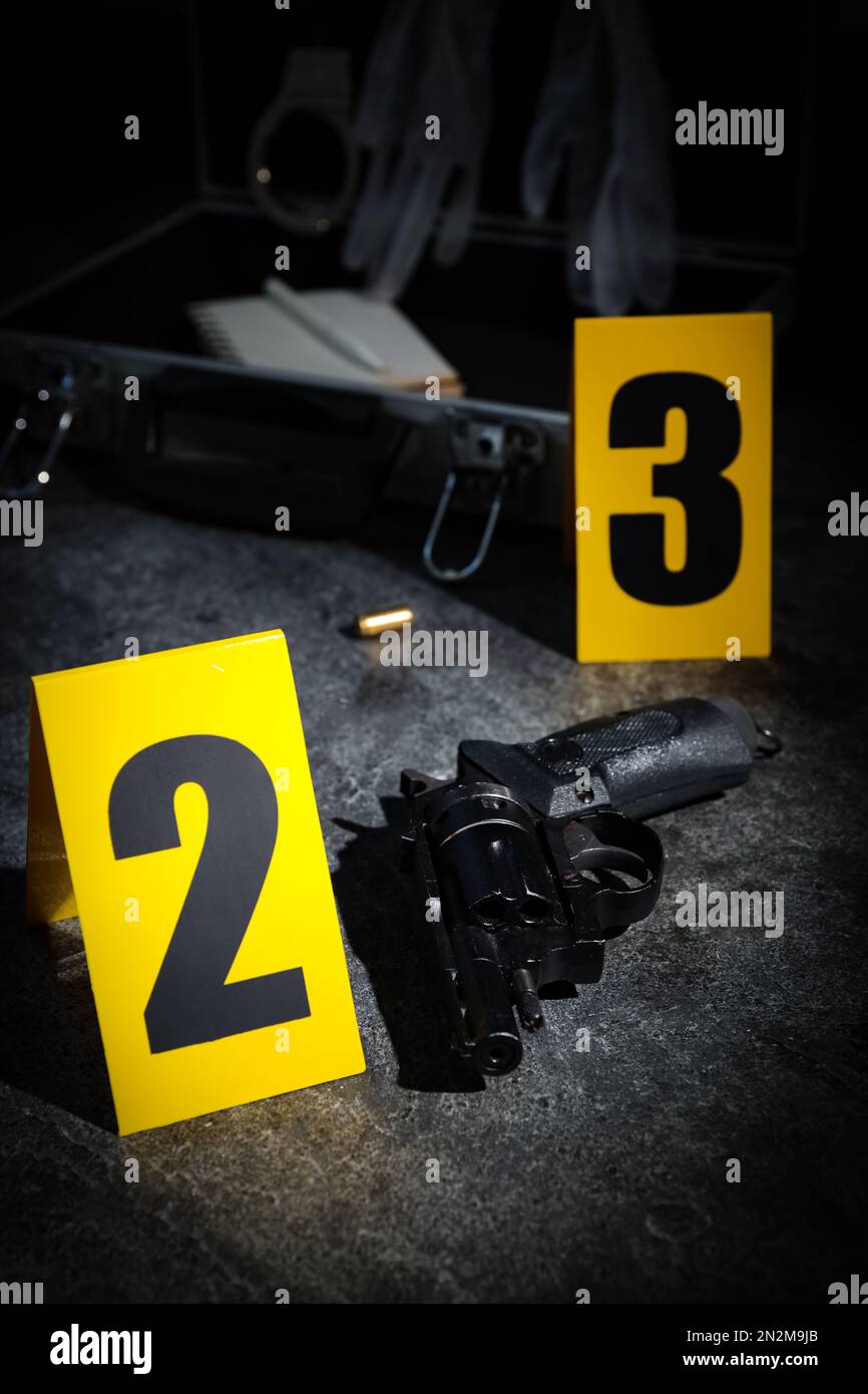 Shell Table Marker Shell casing, gun and crime scene markers on grey stone table Stock ...