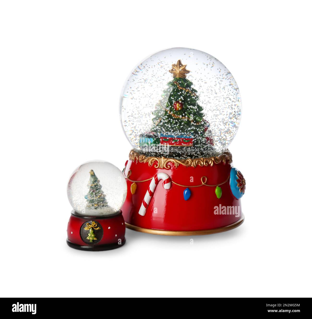 Beautiful snow globes with Christmas trees on white background Stock