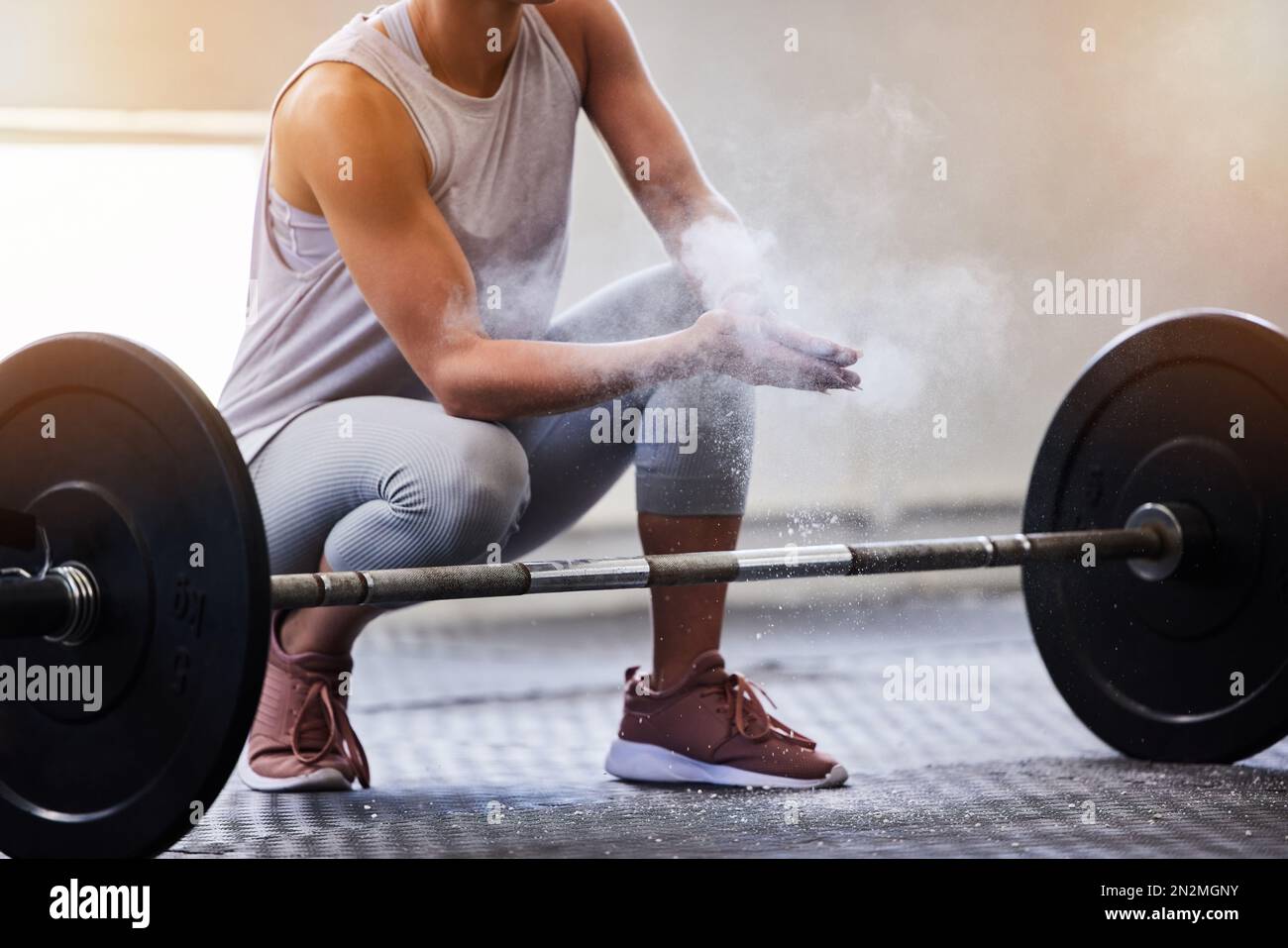 Hands, weightlifting and powder with a woman bodybuilder getting ready