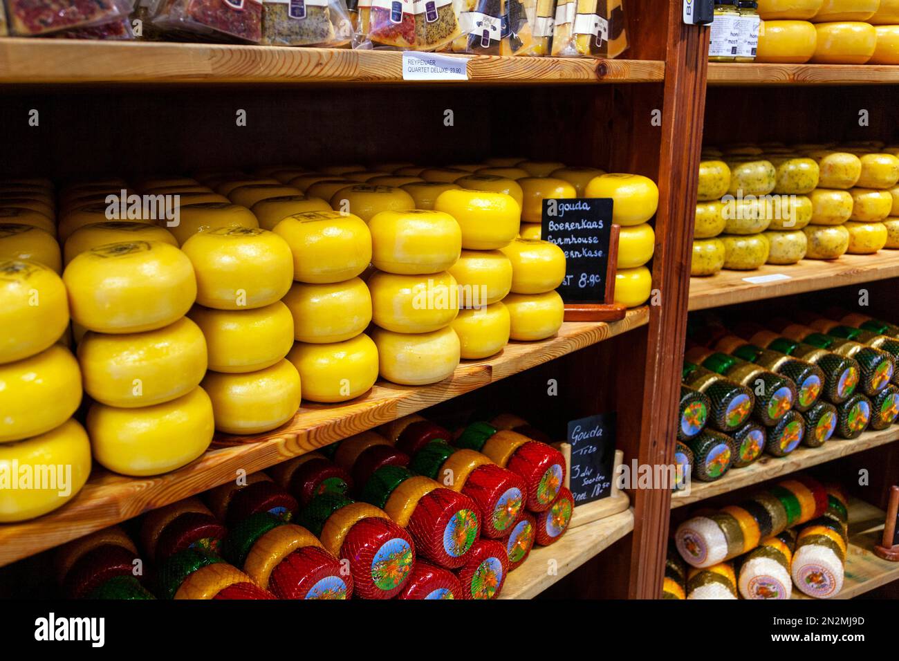 Dutch gouda cheeses on a shelf in a shop, Amsterdam, Netherlands Stock Photo