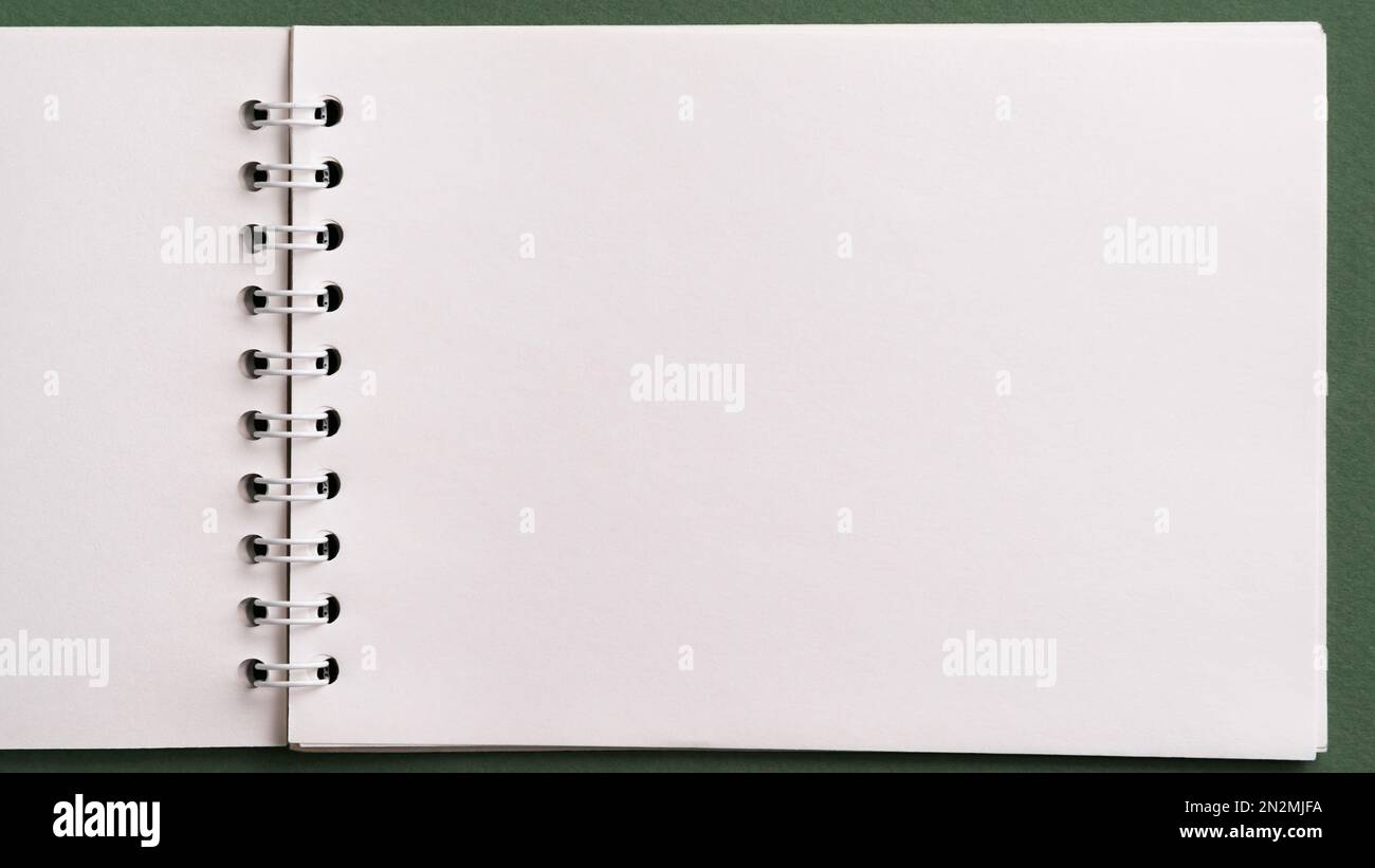 Top view of open blank empty spiral sketchbook notebook notepad with