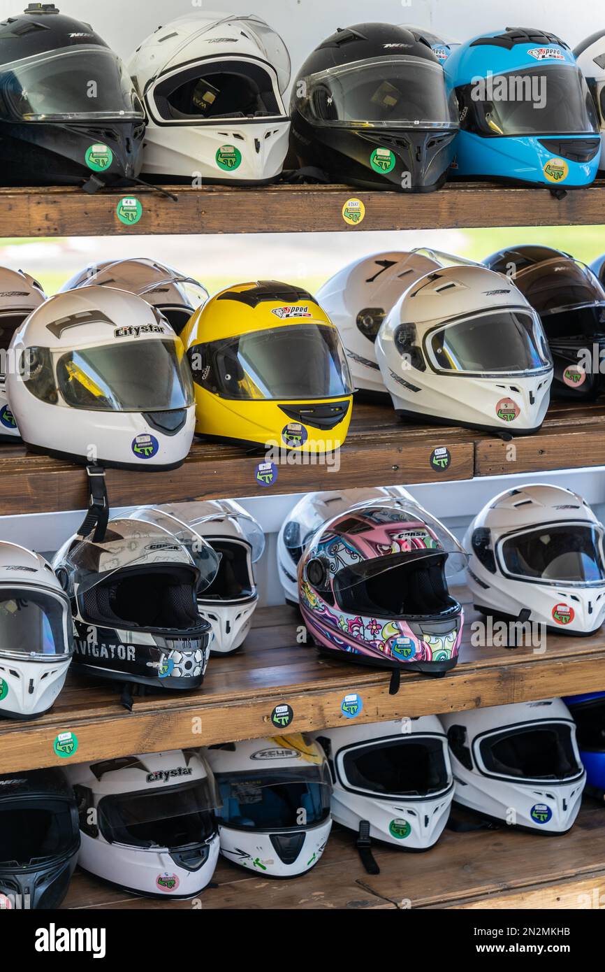 Crete, Greece - August 2022 : Shelves with motorcycle helmets in a bike rental shop Stock Photo