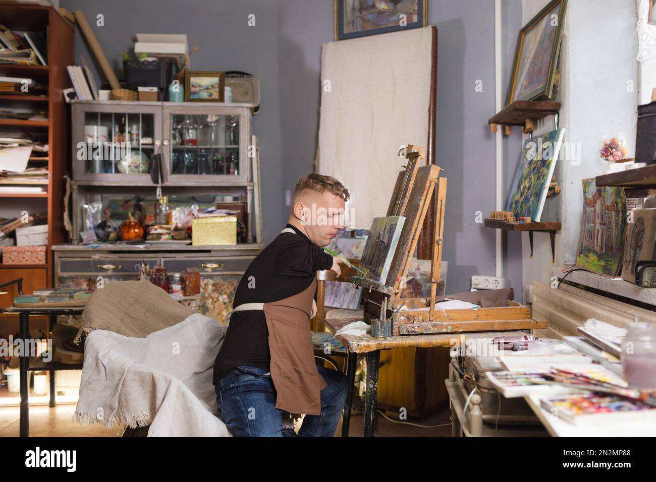 a man with disabilities draws pictures and is engaged in art. Stock Photo