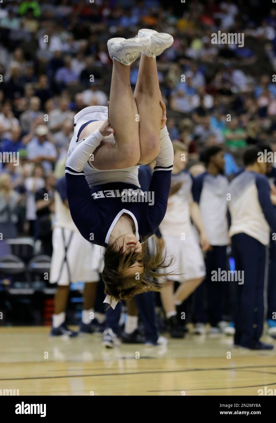 Xavier cheerleader does a somersault during at time out in the first ...