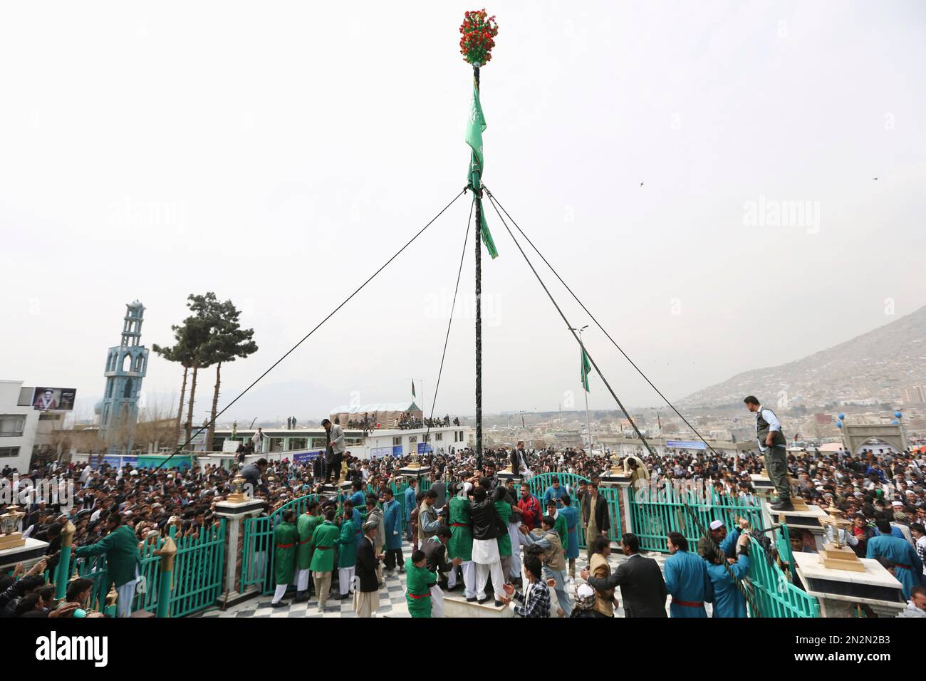 An Afghan Shiite man kisses the holy mace for blessings during