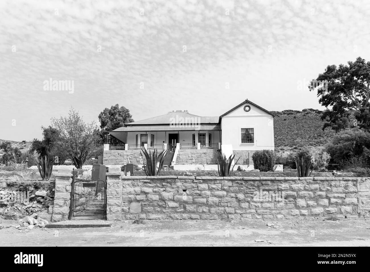 Victoria West, South Africa - Sep 2, 2022: A street scene, an historic house, in Victoria West, in the Northern Cape Karoo. Monochrome Stock Photo