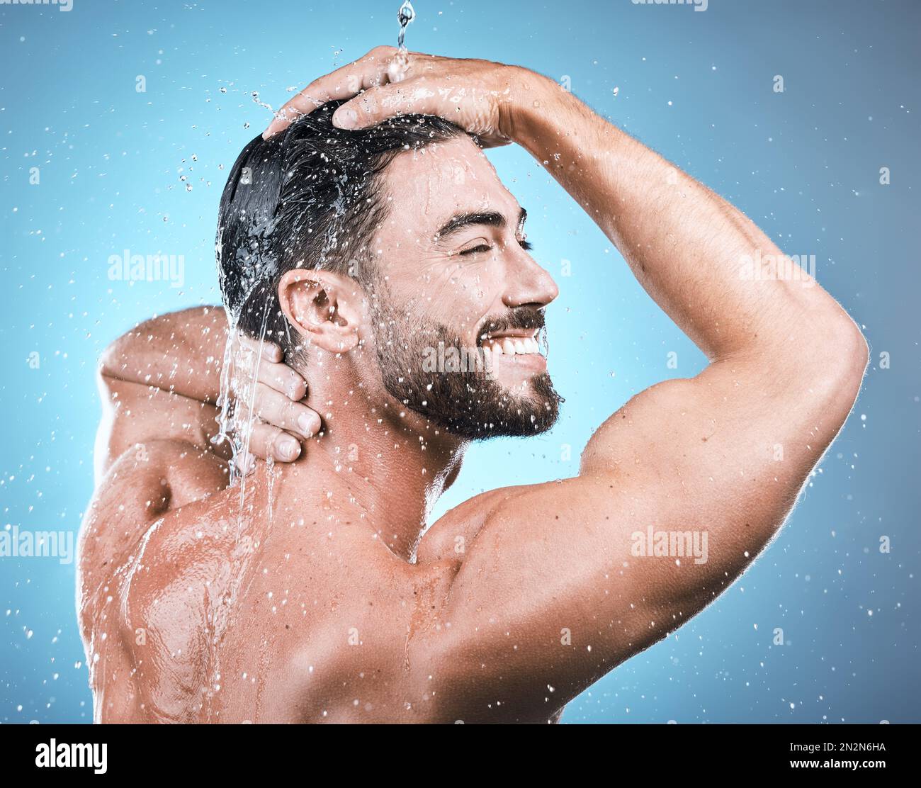 Back skincare, water splash and man in shower in studio isolated on a ...