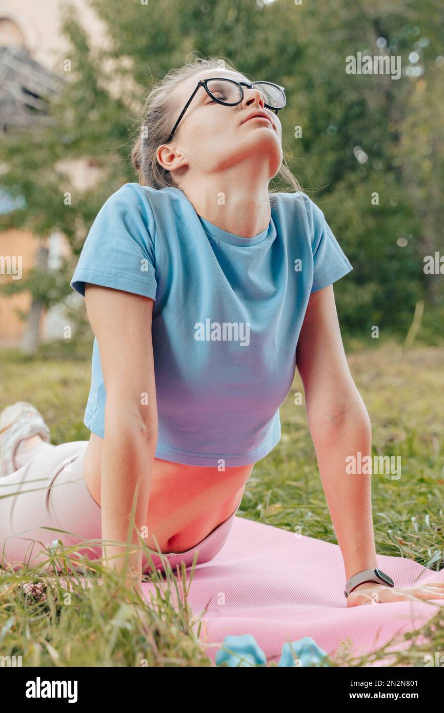 Natural beaty athletic woman relaxing stretching after abs exercises on