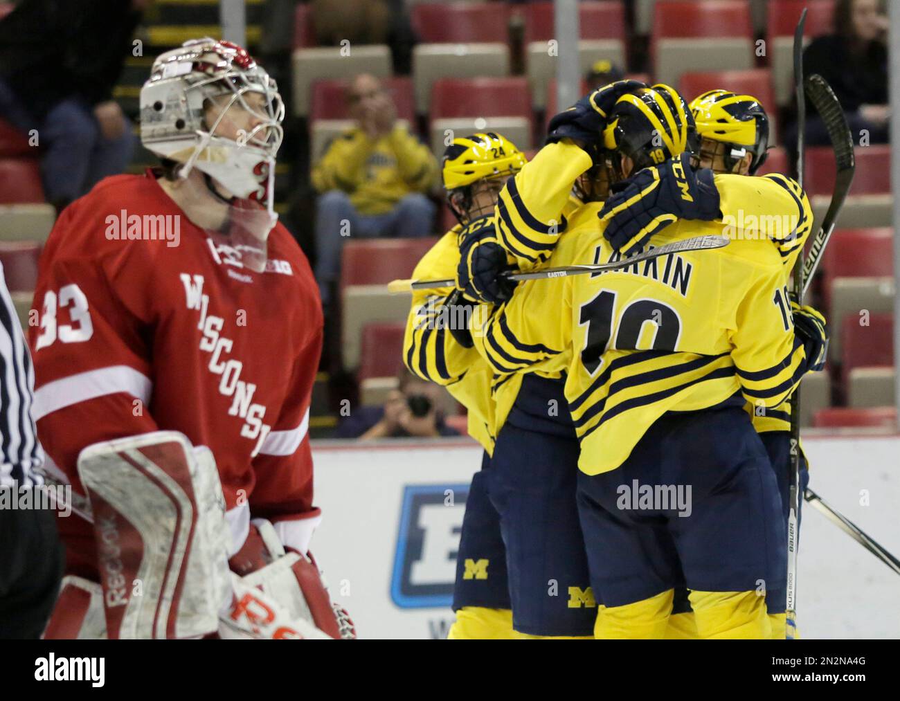 Wisconsin goalie Joel Rumpel (33) skates off as Michigan's Dylan Larkin ...