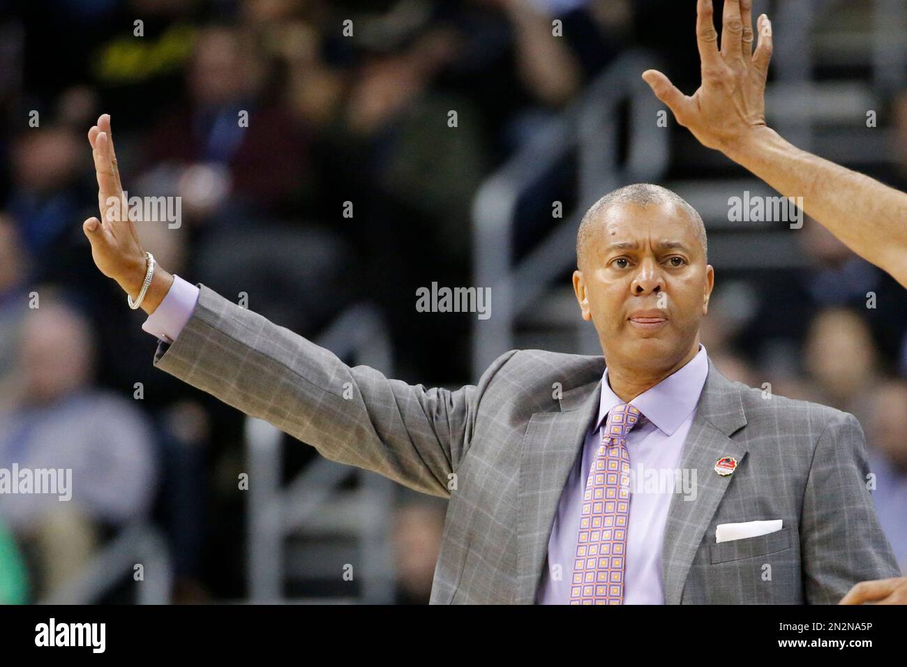 LSU head coach Johnny Jones works court side against North Carolina