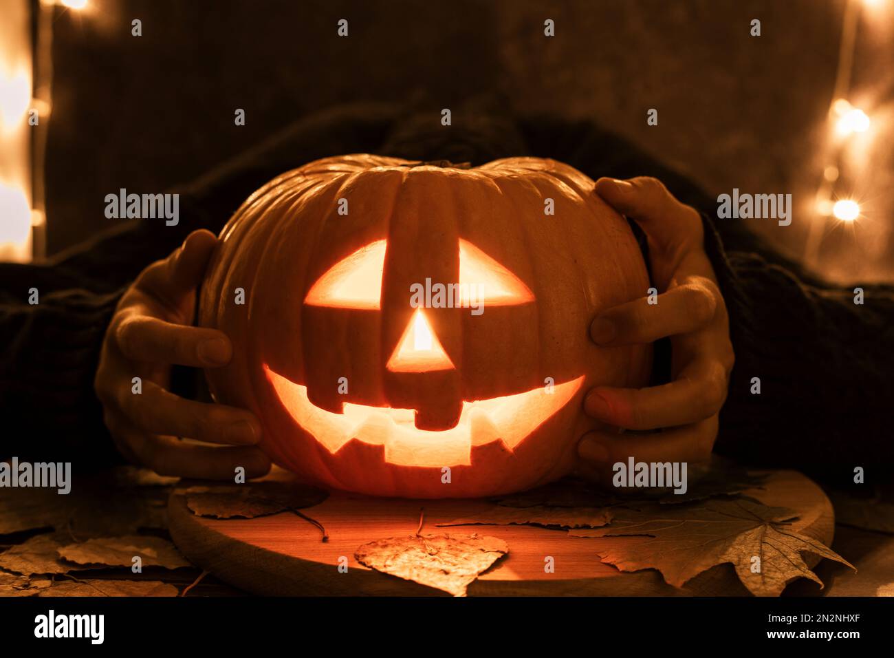 Halloween pumpkin head Jack lantern on dark background with dry leaves ...