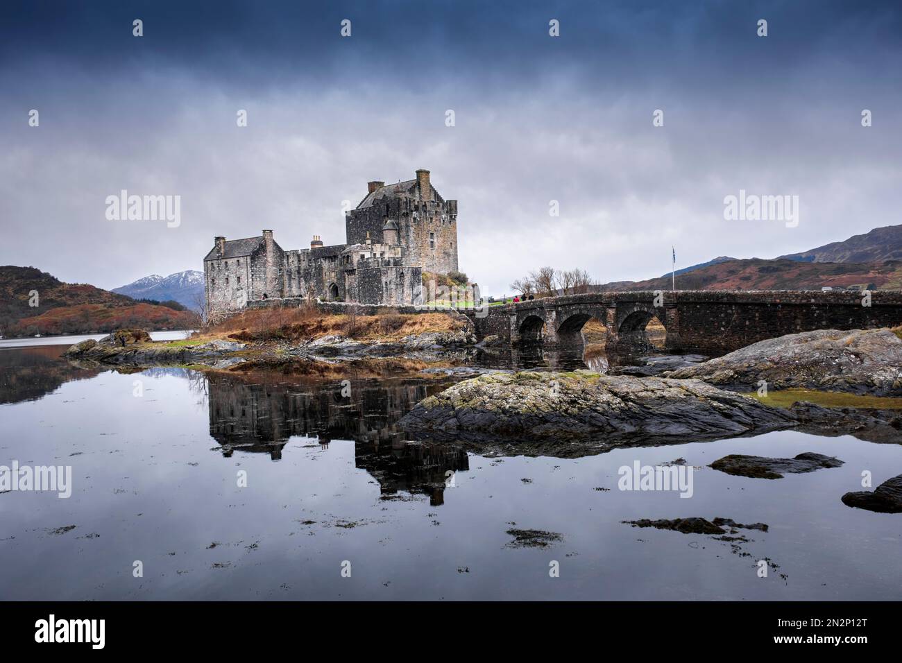 Scotland, Highlands, the medieval Eilean Donan castle, Kyle of Lochalsh, winter view with Loch Alsh lake and snowy mountains Stock Photo