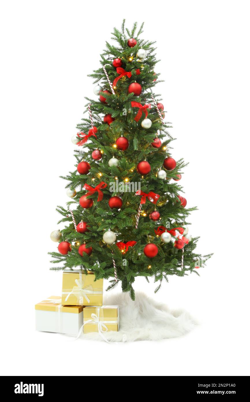 Beautiful decorated Christmas tree with skirt and gift boxes on white ...